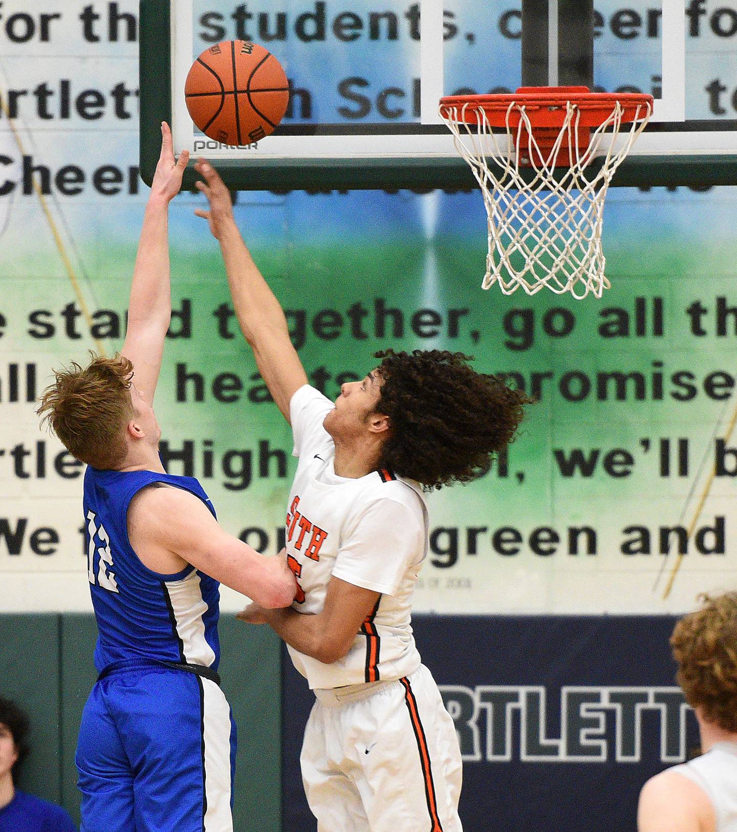 Geneva's Tommy Diamond scores what would be the winning basket over Wheaton Warrenville South's Braylen Meredith in the waning seconds of the Class 4A Bartlett sectional semifinals Wednesday.