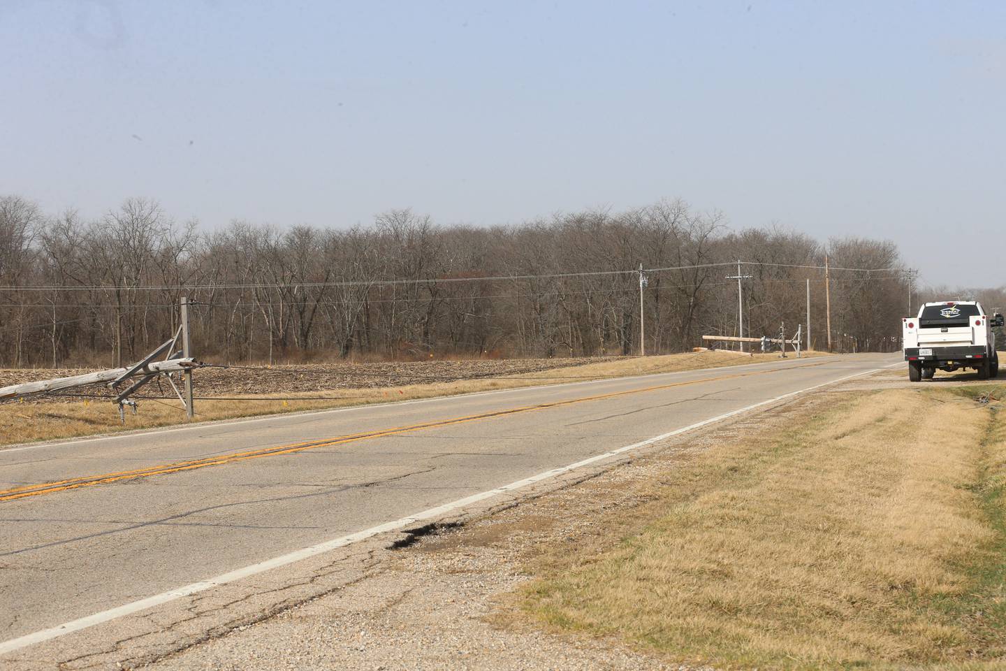 A snapped power poles lay in the ditch as electric crews respond along Illinois Route 71 near the intersection of Holmes Road on Saturday, March 15, 2025 near Hennepin. High winds from Friday's storm caused some power outages across the Illinios Valley.