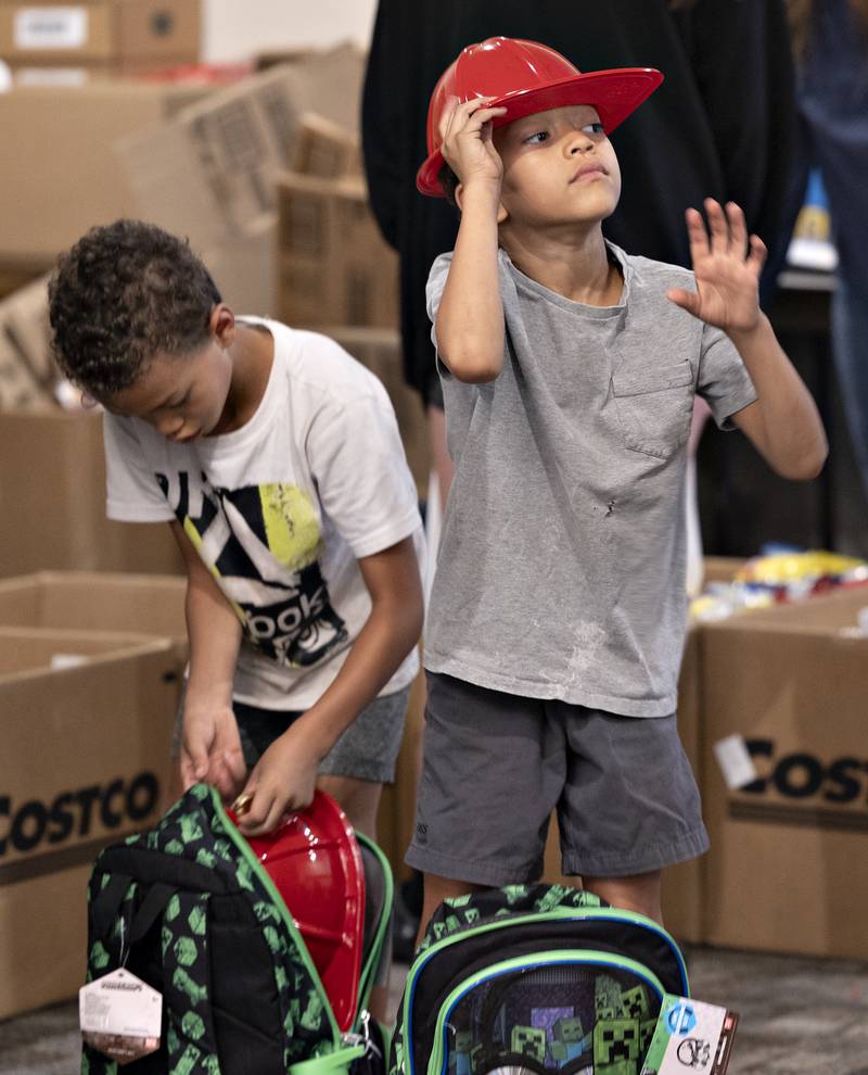 Cayden (left), 7, and Anthony Wallace, 6, check out the swag they picked up Thursday, August 7, 2025, at Dixon’s Tools for School.