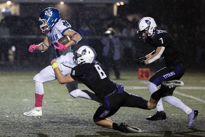 Newman’s Rylan Alvarado is dragged down by El Paso’s Owen Adams Saturday, Nov. 8, 2025.