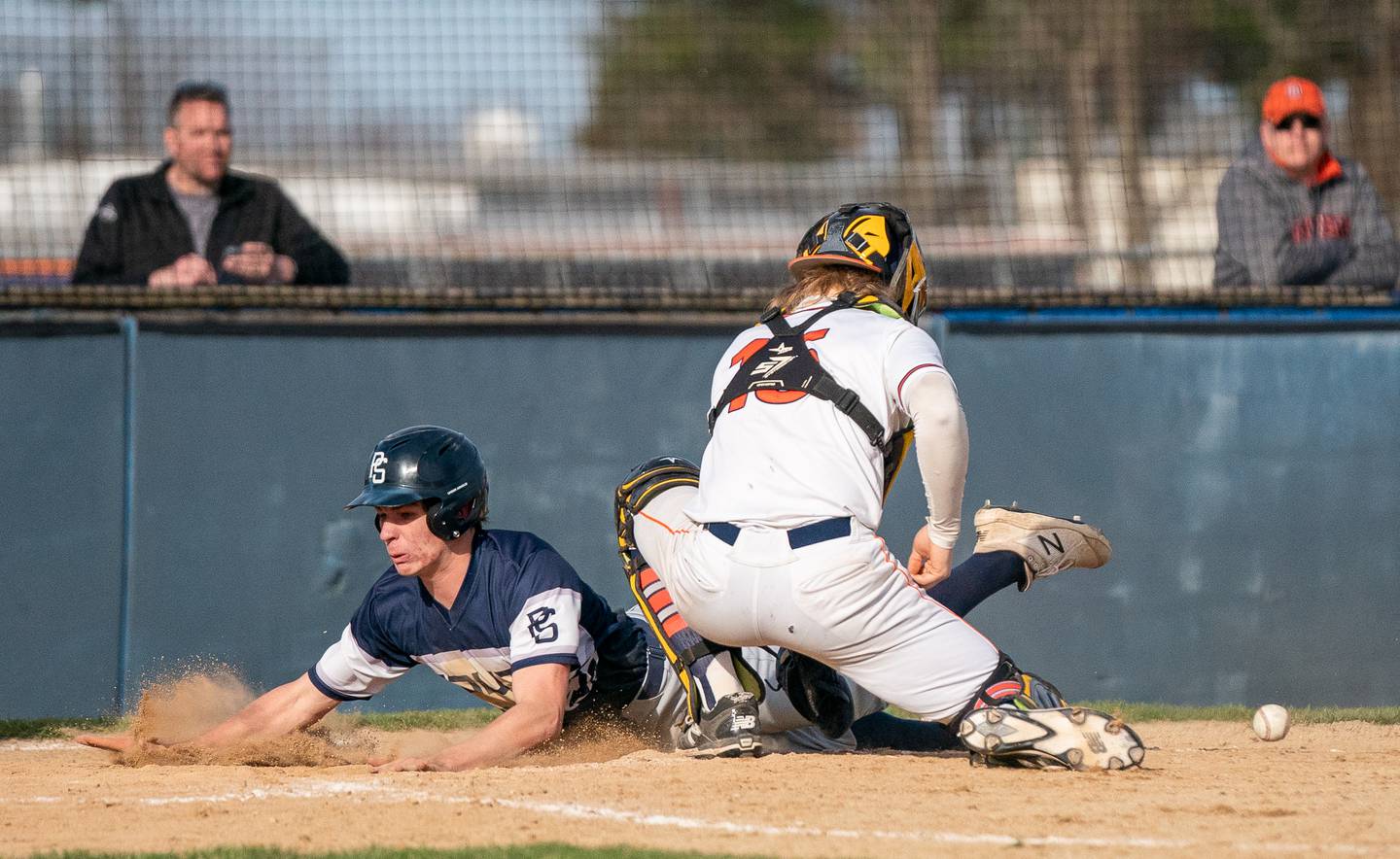 Plainfield South's Ethan Chance (11) slides in to score a run against Oswego’s Hunter Stroud (15) during a baseball game at Oswego High School on Monday, April 11, 2022.