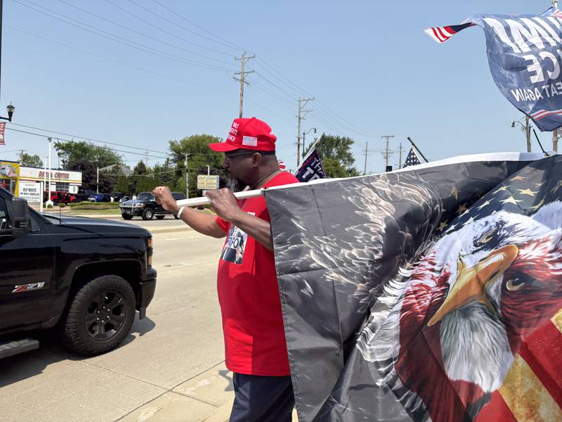John Russell dances during a rally outside the Trump and Truth Store in Huntley May 31, 2025.