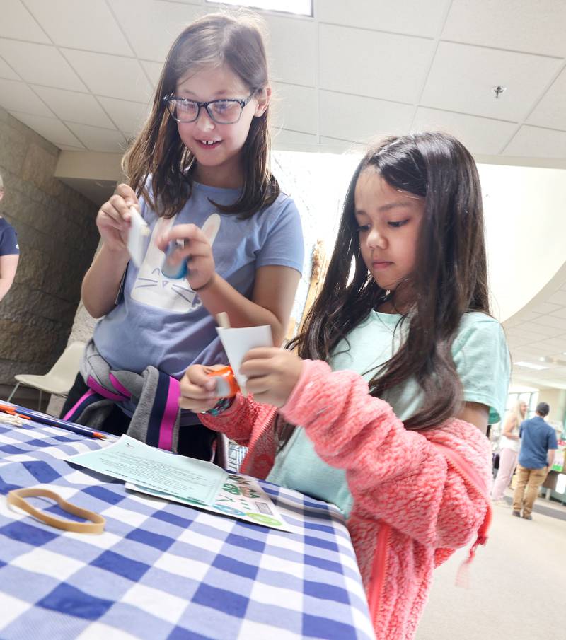 Aletta Sexton, (left) 9, from Lee, and Naya Collins, 9, from Sycamore build bee buzzer noise makers during the 4-H General Project Show Thursday, July 14, 2022, at the DeKalb County Farm Bureau in Sycamore.