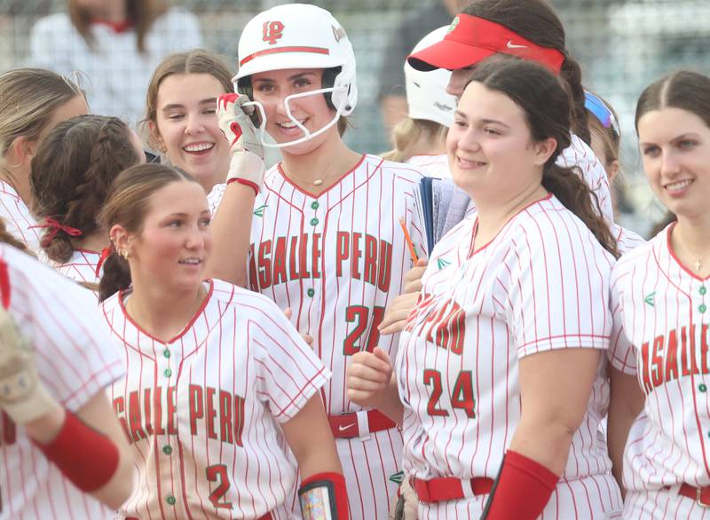 L-P's Anna Riva (top-middle) is greated by teammates after hitting a home-run on Friday, March 20, 2026 at the L-P Athletic Complex in La Salle.