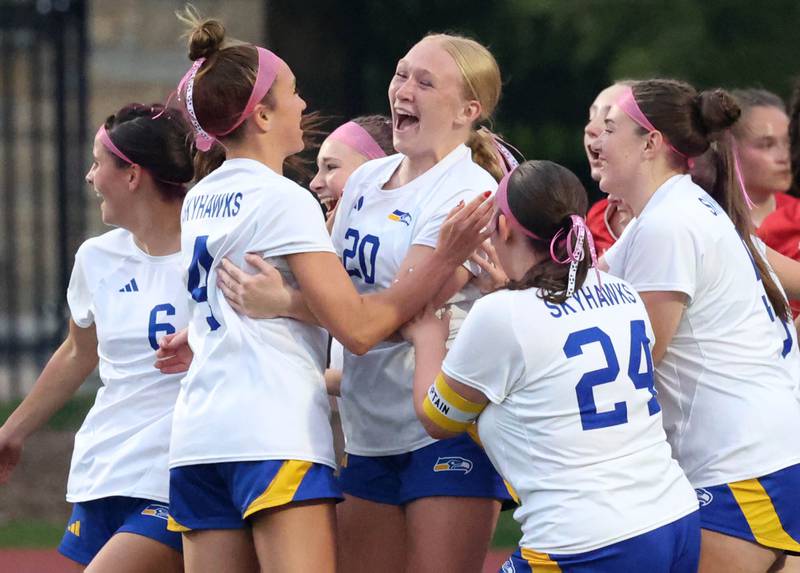 Johnsburg's Kayla Hiller (middle) is mobbed by her teammates after scoring a goal Thursday, June 5, 2025, during their IHSA Class 1A state semifinal game against Timothy Christian at North Central College in Naperville.