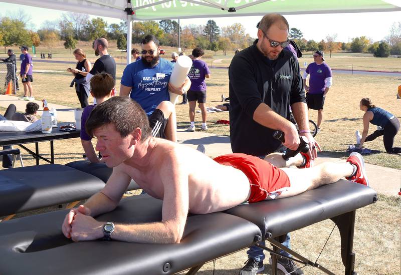 Second place finisher Andy Olson gets a massage from  Physical Therapist/Clinic Director Tyson Goken of Ivy Rehab after the Sugar Grove Park District’s inaugural Run to Remember 5K & Fun Run on Saturday, Oct. 19, 2024 in Sugar Grove.