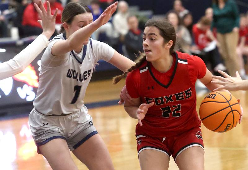 Yorkville's Sydney McCabe drives the lane against Oswego East's Aubrey Lamberti during their game Tuesday, Feb. 11, 2025, at Oswego East High School.