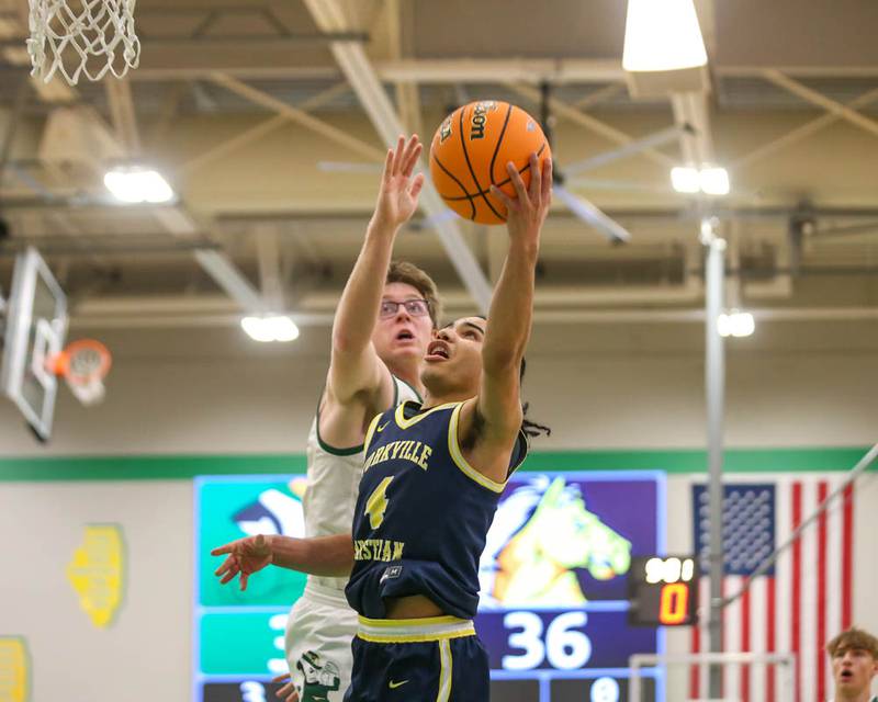 Yorkville Christian's Tray Alford (4) puts up a shot while being defended by Bishop Mcnamara's Callaghan O'Connor (33) during their Class 2A Seneca Sectional final basketball game between Bishop McNamara at Yorkville Christian, March 6, 2026 in Senaca.