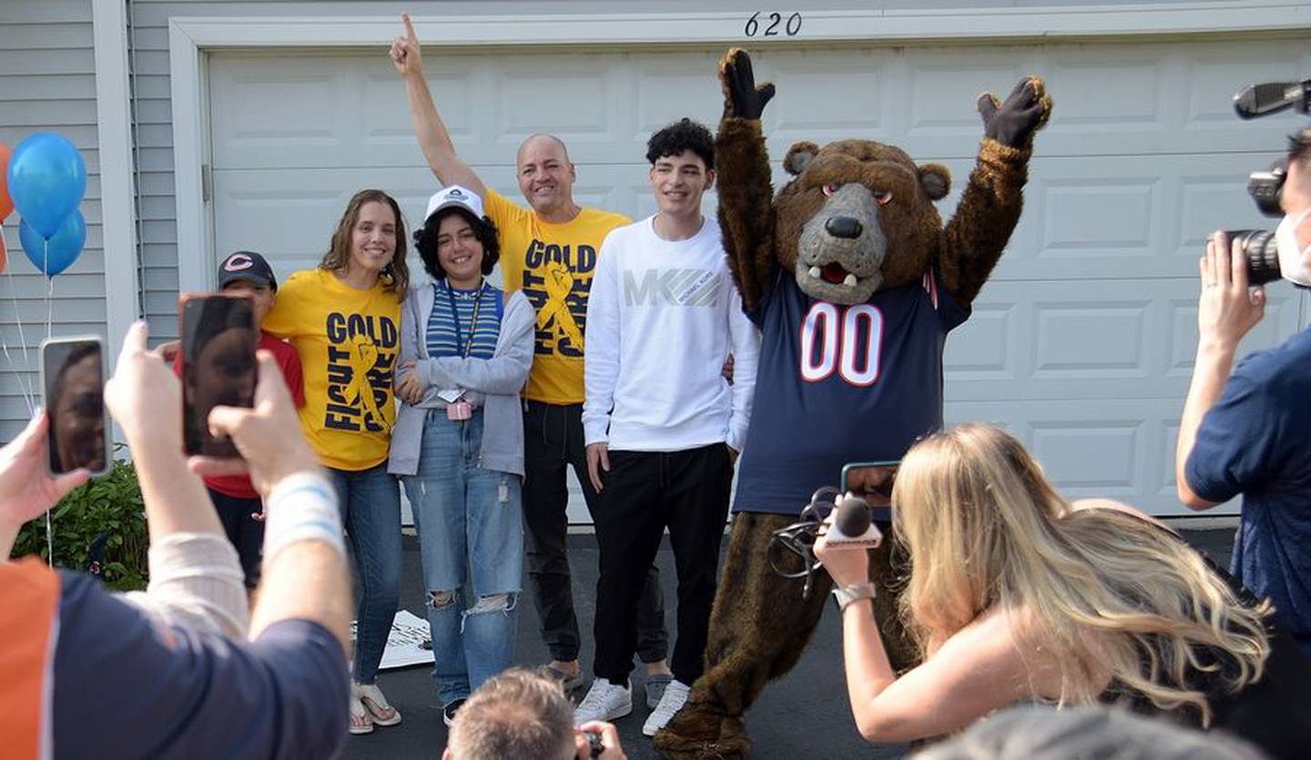 Fourteen-year-old cancer patient Kaylah Gonzalez poses for photos Wednesday with her family and Staley Da Bear after she was given a surprise trip to the Chicago Bears game Sunday in Green Bay.