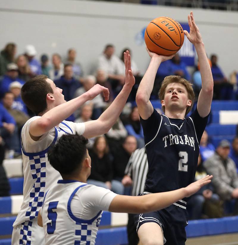 Cary-Grove's AJ Berndt (right) shoot the ball over Burlington Central's Colton O'Neil (left)  and Cedric Ceniza (center) during a Fox Valley Conference boys basketball game on Friday, February. 6, 2026, at Burlington Central High School.