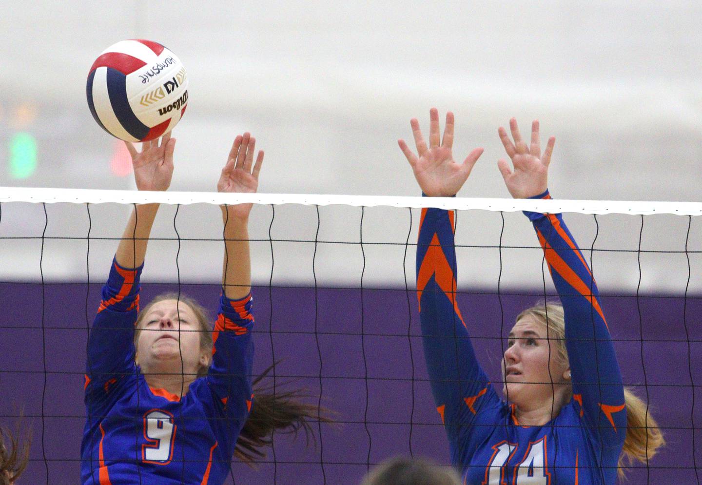 Genoa-Kingston’s Annabelle Peters, left, and Keiragan Gleissner block against Marian Central in varsity volleyball tournament action on Saturday, Sept. 21, 2024, at Hampshire High School in Hampshire.