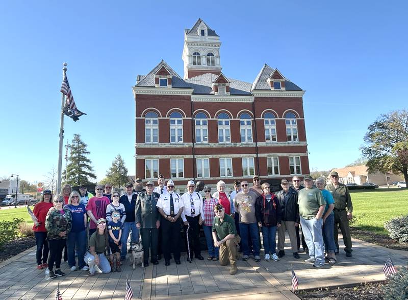 Veterans and their families gathered with city officials on the Ogle County Courthouse Square to watch the installation of the first Hometown Hero banner on Thursday, April 23, 2026 in downtown Oregon. Twenty banners featuring photos of local veterans are scheduled to be installed around the courthouse square along state highways 64 and 2.