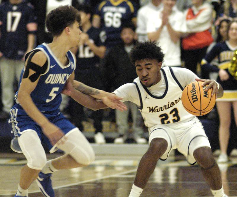 Sterling's Kaedon Phillips battles Quincy's Kameron Wires. The action took place on Friday, December 13th at Sterling.