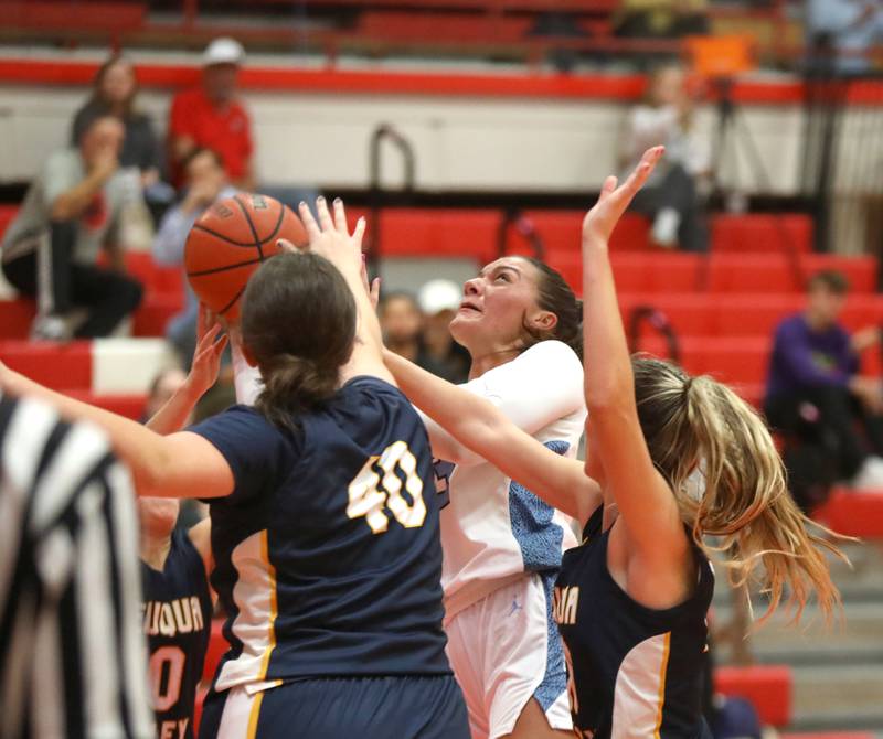 Nazareth’s Danielle Scully (center) tries to get to the basket between a pair of Neuqua Valley defenders during a game at Hinsdale Central on Thursday, Nov. 16, 2023.