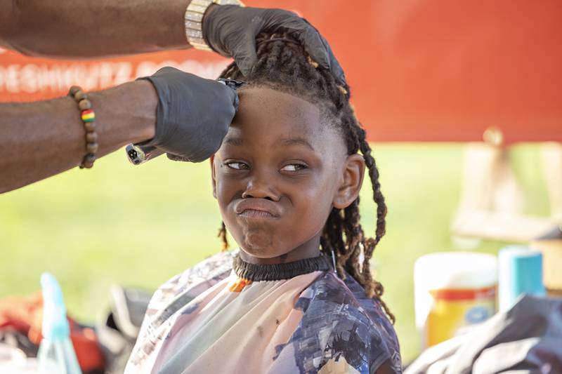 Ja’myrin Jones, 8, gets a fresh new cut at Ben’s Phresh Kutz booth Tuesday, August 5, 2025, at Sterling’s National Night Out. The barber shop offers discounted cuts for students to look spiffy going back to school.