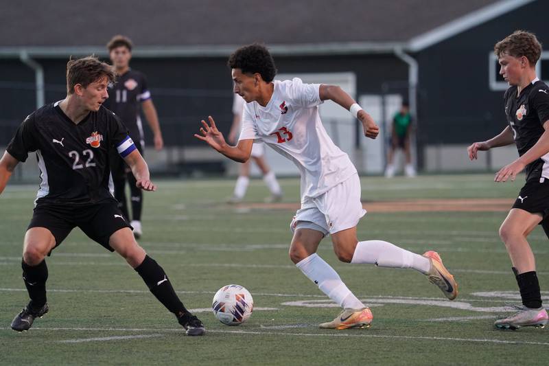 Oswego’s Alexander Nieves (23) plays the ball against Wheaton Warrenville South's Jay Weber (22) during a soccer match at Wheaton Warrenville South in Wheaton on Thursday, Aug 28, 2025.