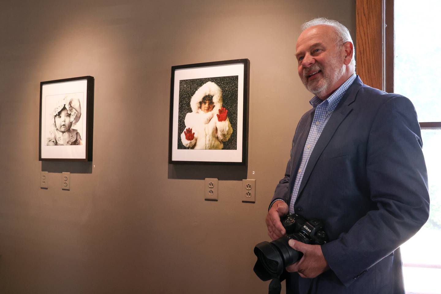 Bill "BJ" Jurevich, a longtime Daily Journal photographer, talks about photos of his two daughters, Annie, left and Jamie, which are featured in a new gallery of his life's work titled, Life Through the Lens: A Photographic Retrospective, which runs through Oct. 25 at the Victorian House Gallery, 577 S. Main Street in Bourbonnais.