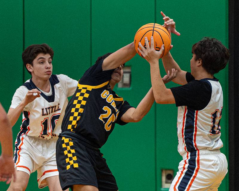 Edward Rodriguez (10) of DePue watches on as Tanner Gullquist (20) of Reed-Custer and Javier Rosales (12) of DePue fight over possession of ball during game in the Shipyard Showdown on Tuesday, December 23, 2025 at Seneca High School in Seneca.