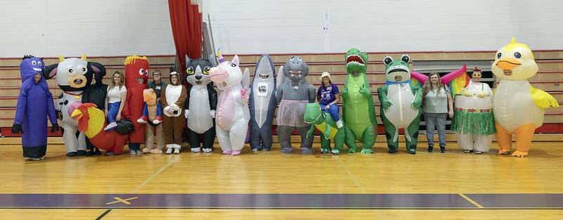 Seventeen moms donned inflatable costumes Wednesday, May 21, 2025, to celebrate their graduating Dixon High School seniors. The moms surprised their students as they made one last walk through at Reagan Middle School. Pictured: Makenzie Simpson (left), Sarah Wilson, Jaylee Dugger, Amber Bishop, Monique Weidman, Sara Leisner, Shawn Southard, Liz Detig, Christy Zepezauer, Darla Foulker, Courtney Teller, Brooke Steder, Lauren Cecchetti, Shannon Mowery, Cynthia Frey, Tonya Yingling and Paige Toms.