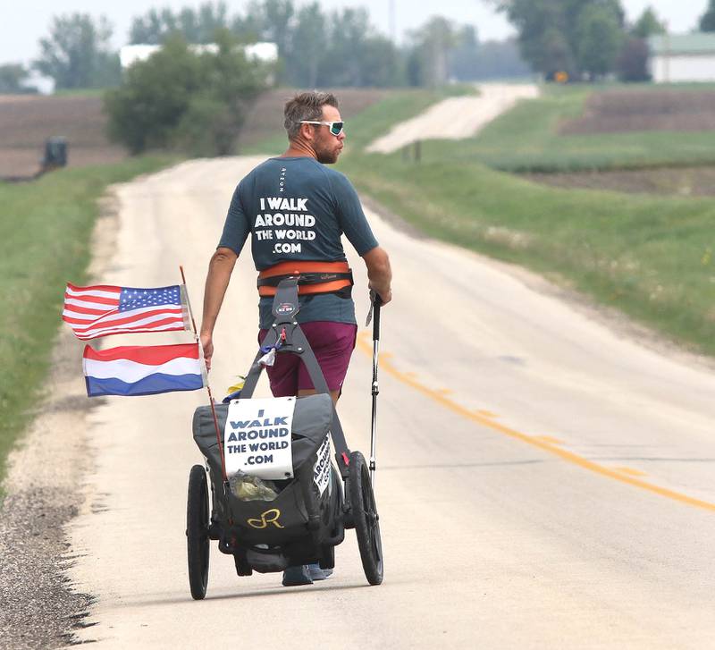 Tom Boerman, from the Netherlands, walks north on Ault Road near Kirkland Tuesday, May 24, 2022, hoping to make it to Rockford by the end of the day. Boerman, who stopped for the night at a home in DeKalb, is on a quest to walk around the world while raising money for schools in Nepal that were hit hard by the 2015 earthquake in the region.