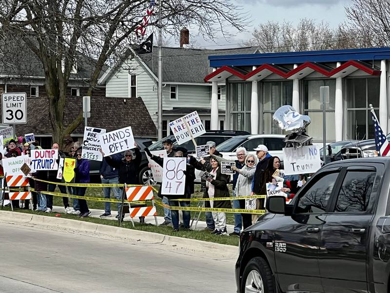 Protestors gather in front of the Grandon Civic Center and the post office on Saturday, April 5, in Sterling to voice concerns over President Donald Trump and his administration.