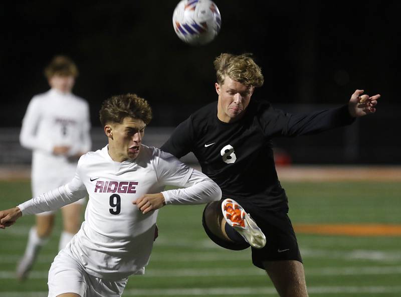 McHenry's Braeden Juergensen (right) kicks the ball away from Prairie Ridge's Henry Knoll during a Fox Valley Conference soccer match on Tuesday, Oct. 15, 2024, at McCraken Field in McHenry.