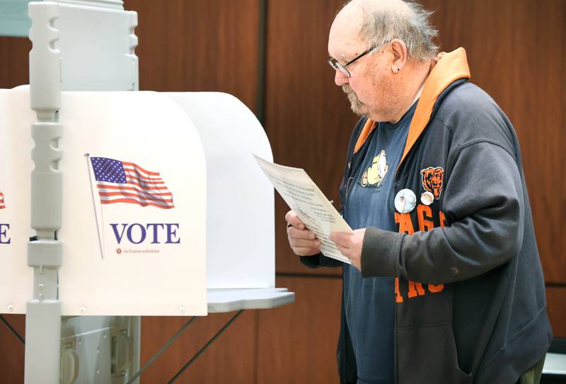 DeKalb resident Steve Walt finishes casting his ballot on Election Day Tuesday, April 4, 2023, at the polling place in Barsema Alumni and Visitors Center at Northern Illinois University in DeKalb.