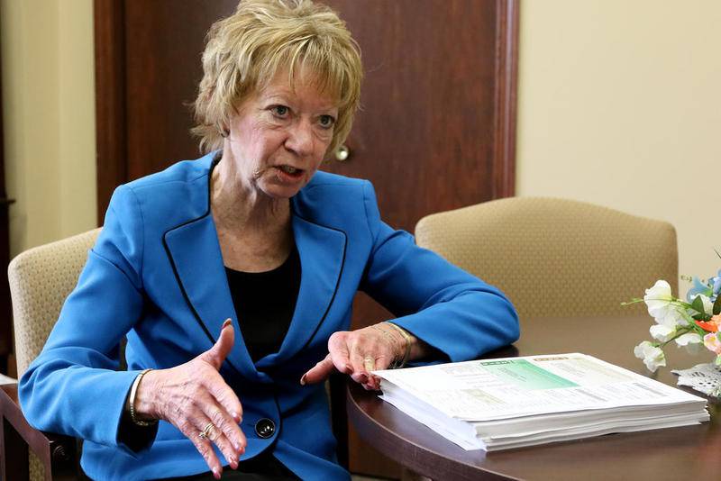 McHenry County Treasurer Glenda Miller goes over property tax forms inside her office on May 1 in Woodstock.