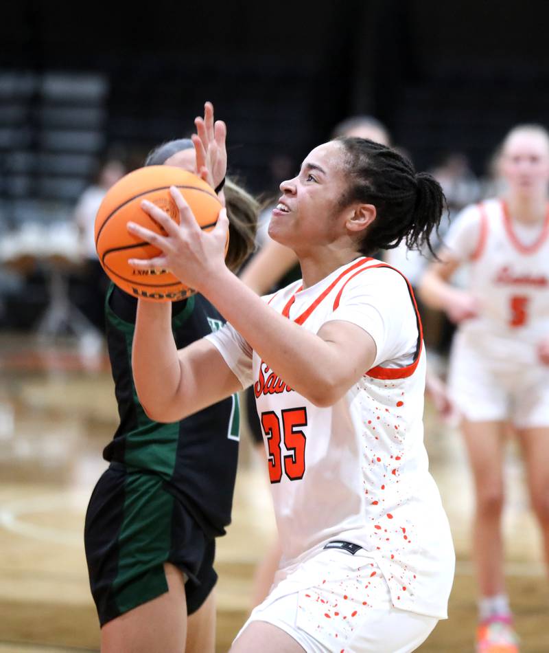 St. Charles East's Corinne Reed looks for an opening during a Class 4A St. Charles East Sectional semifinal against Glenbard West on Tuesday, Feb. 25, 2025 in St. Charles.