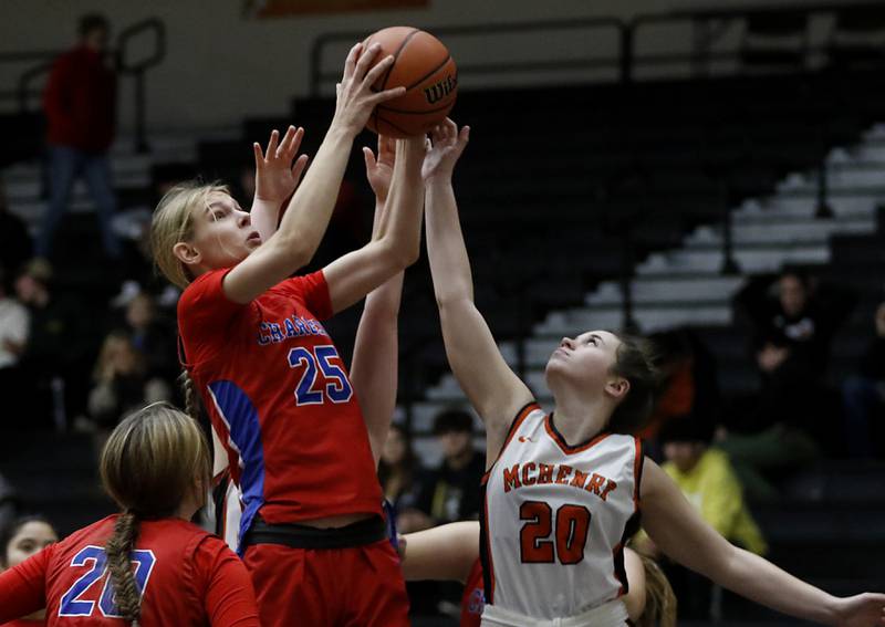 Dundee-Crown’s Monica Sierzputowski grabs a rebound in front of McHenry's Amber Bock during a Fox Valley Conference girls basketball game on Tuesday, Dec. 12, 2023, at McHenry High School.