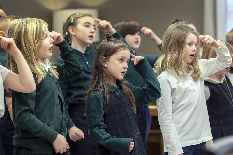 St. Andrew’s first through third grade students act out a song for residents Thursday, Jan. 30, 2025, at Morningside of Sterling. The senior living facility was one of two facilities the school visited as part of their community outreach.