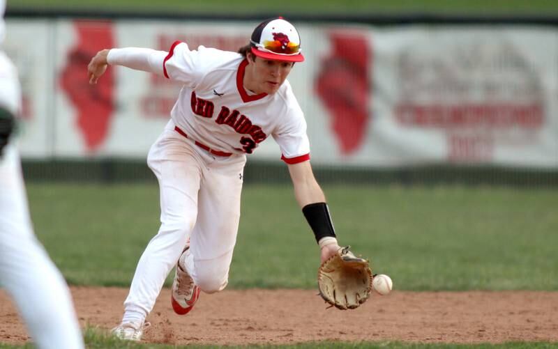 Huntley’s Griffin Goldstein fields in infield chopper against Jacobs in varsity baseball Wednesday at Huntley.