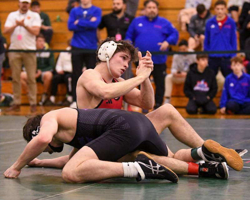 Aidan Huck of Batavia, back, celebrates his win over Marmion Academy's wrestler Ashton Hobson during the regional title match in the 144 weight class held on Saturday Feb. 3, 2024 at Glenbard West High School.