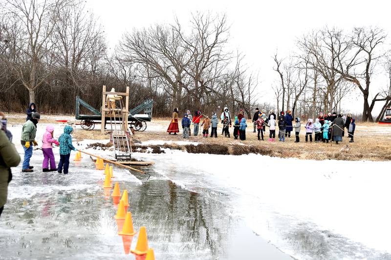 Historical interpreters and participants at Kline Creek Farm work to harvest ice on Friday, Jan. 24 2025 in West Chicago.