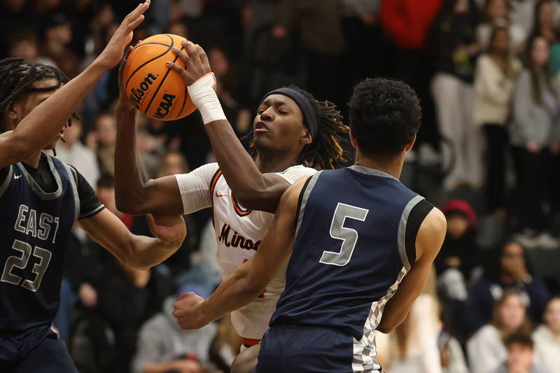 Minooka’s Nehemiah Brown battles his way to the basket against Oswego East on Friday, Jan. 16, 2026 in Minooka.