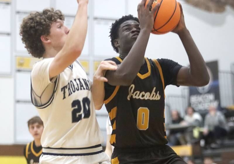 Jacobs’ Samson Averehi, right, shoots past Cary-Grove’s Ryan Boutwell during Hinkle Holiday Classic varsity boys basketball tournament action on Thursday, Dec. 26, 2024 at Jacobs High School in Algonquin.
