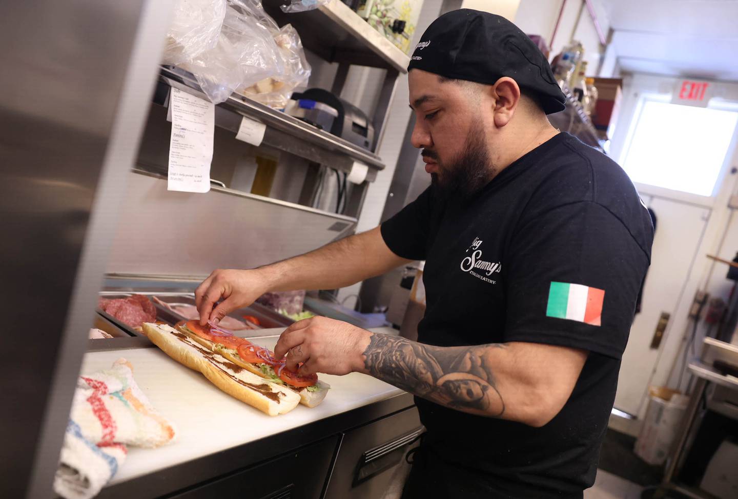 Cook Marco Galan prepares a sandwich at Big Sammy’s Italian Eatery in downtown Plainfield. Friday, Feb. 25, 2022, in Plainfield.