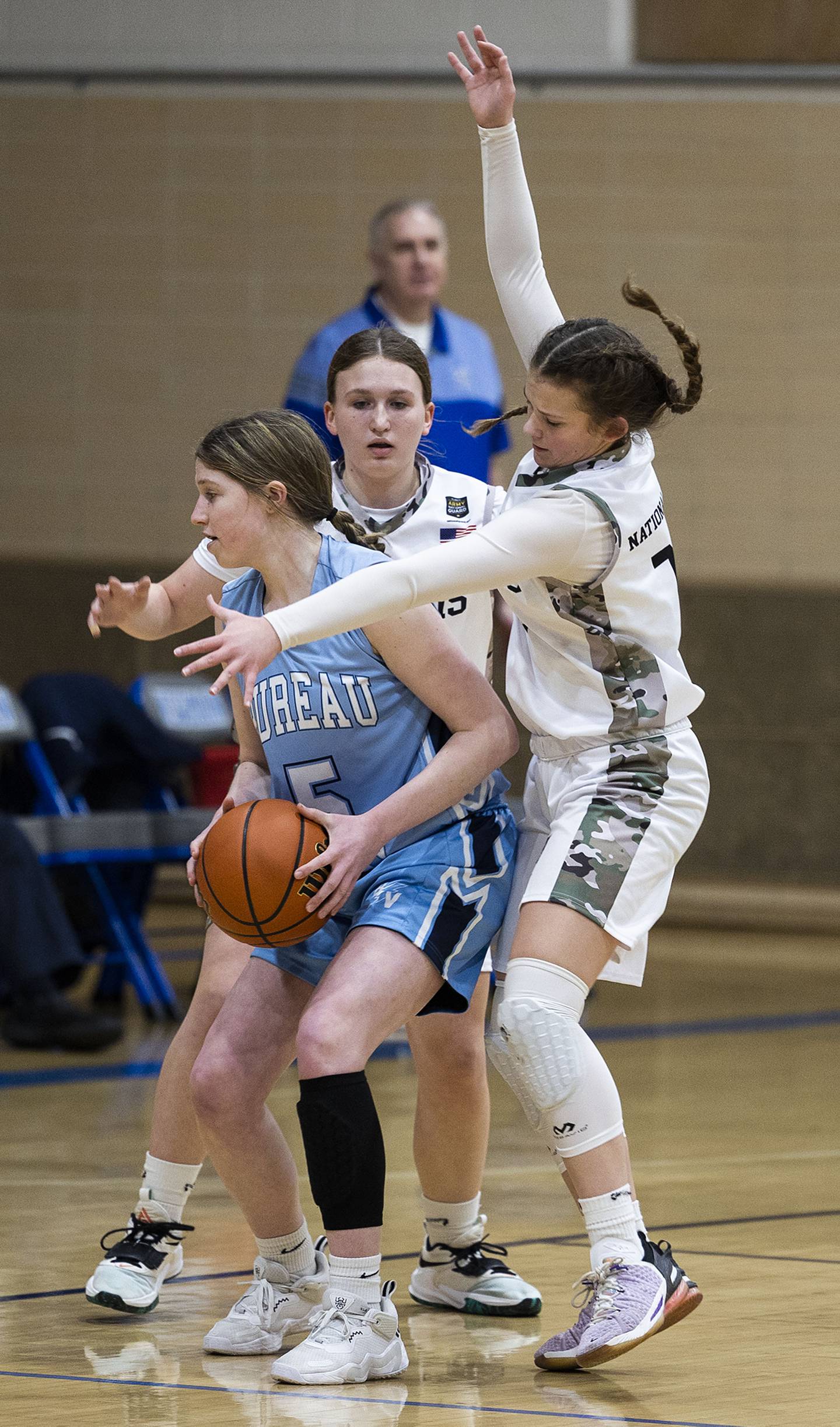 Bureau Valley’s Kate Salisbury keeps the ball away from Newman defenders Monday, Jan. 23, 2023.