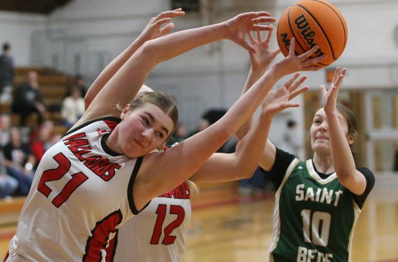 Henry-Senachwine's Brooklynn Thompson misses a rebound as St. Bede's Parker McClain sprints to the ball on Thursday, Jan. 30, 2025 at Henry-Senachwine High School.