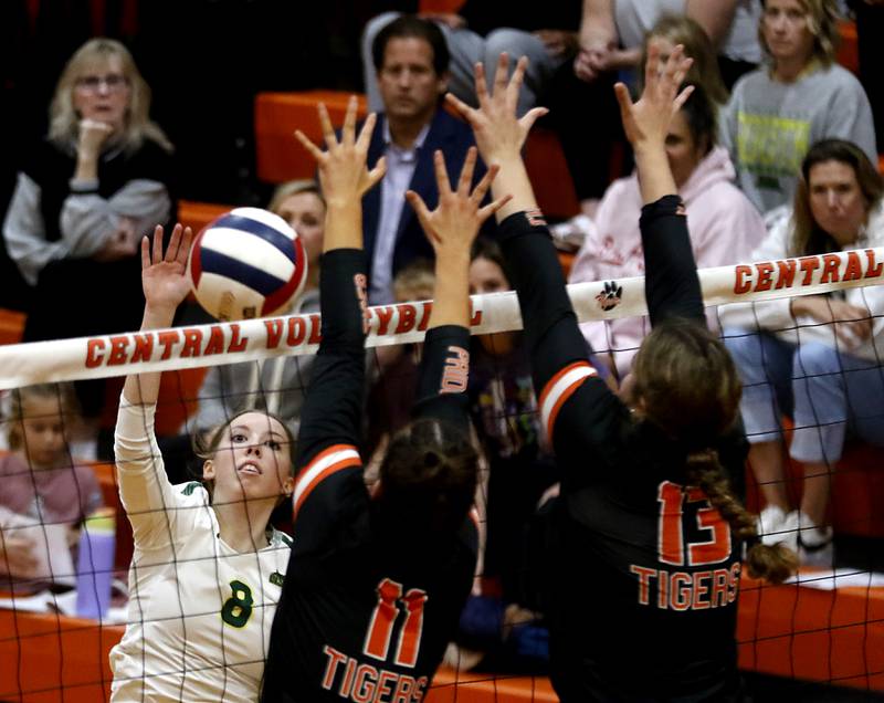 Crystal Lake South's Anna Hougas (left) hits the ball past the block of Crystal Lake Central's Emily Mazza (center) and Crystal Lake Central's Siena Smiejek (right) during the IHSA Class 3A Crystal Lake Central Regional volleyball final on Oct. 31, 2024, at Crystal Lake Central High School.