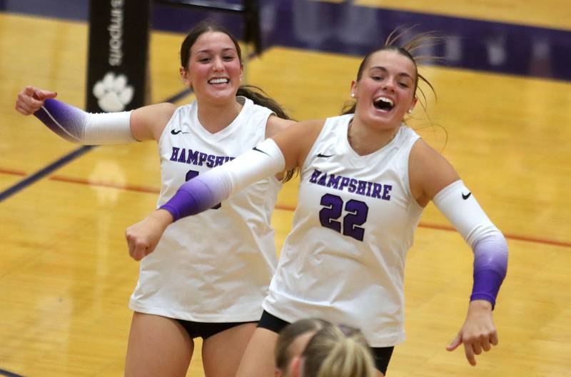 Hampshire’s Katelynn Petterson, left, and Kylie Lambert celebrate a point in their two-set win over Huntley in varsity girls volleyball at Hampshire High School in Hampshire on Tuesday, Sept. 23, 2025.