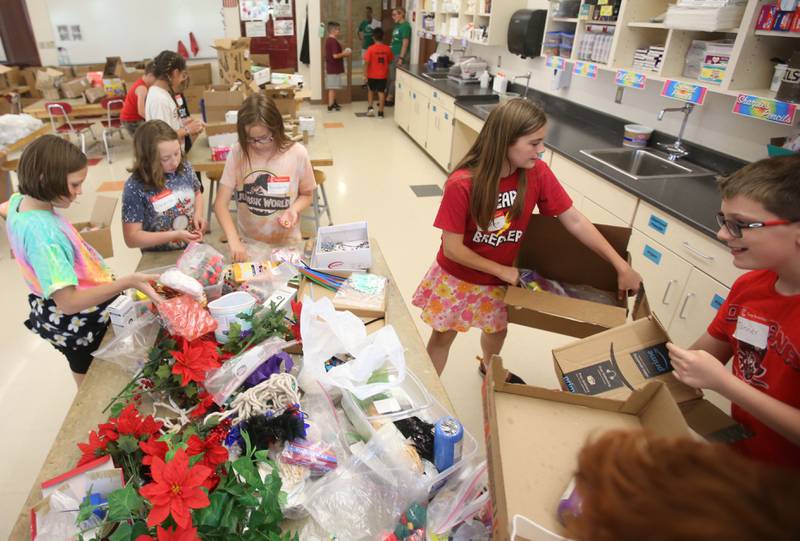 Students look through recycable items to use for there projects during the Camp Invention on Wednesday, ?June 5, 2024 at Central Intermediate School in Ottawa. For over 30 years, the National Inventors Hall of Fame has inspired millions of chldren through it's flagship summer program. The weeklong program is led by qualified local educators in the Ottawa area along with local high schoolers volunteering. The camp is for students from kindergarten through sixth grades. Donations were made possible from Covia, US Silica, CAVIC, Financial Plus, Pilkington and community members. With the help of donations,  A total of 74 students were able to participate in this years camp.