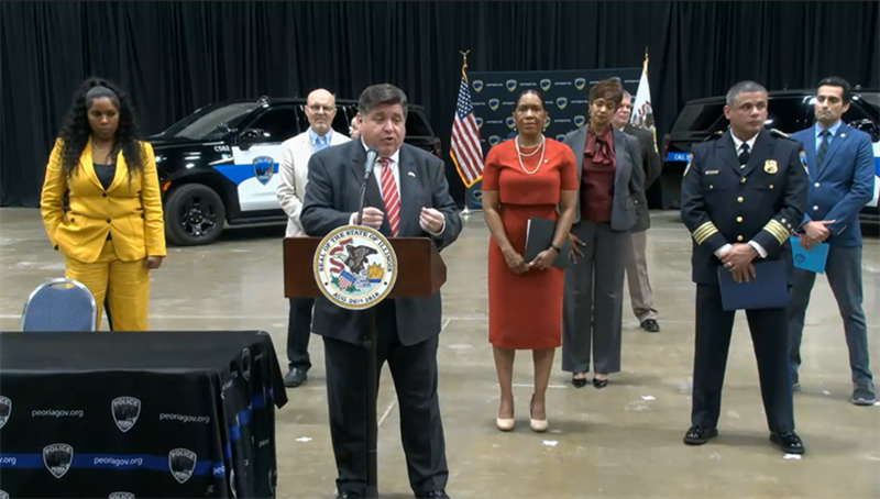 Gov. JB Pritzker takes questions at a news conference after signing a public safety measure Tuesday in Peoria.
