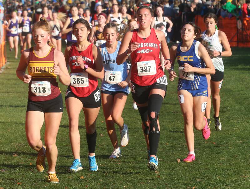 Richmond Burton's Emerson Wold (left) and Aurora Central Catholic's Ailidzie Perez (right) compete in the Class 1A Cross Country Finals on Saturday, Nov. 4, 2023 at Detweiller Park in Peoria.