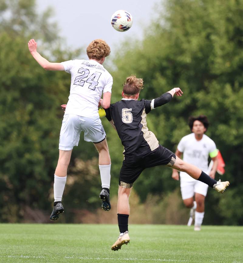 Kaneland's Tyler Adams (left) and Sycamore's Aiden Sears go up for a header during their game Monday, Oct. 6, 2025, at Sycamore High School.