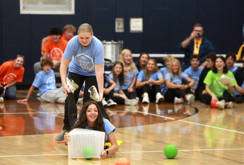 Nazareth Academy freshmen Mae Murphy (standing) and Mia Moreno compete in a game based on Hungry Hungry Hippos on Friday, Sept. 27, 2024 during the La Grange Park school’s annual Homecoming Pep Rally.