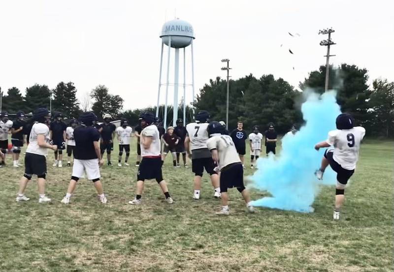 Bureau Valley senior lineman Blake Erickson kicks the ball to reveal the gender of the baby of Storm coach Mat Pistole and his wife, Lindsey, which is due March of 2024.