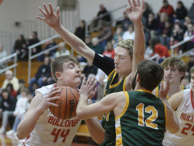 Streator’s Nolan Lukach tries to shoot over the blocks of Coal City’s Garrett Keeley and Carson Shepard in the 1st period on Tuesday, Jan. 31, 2023 at Streator High School.