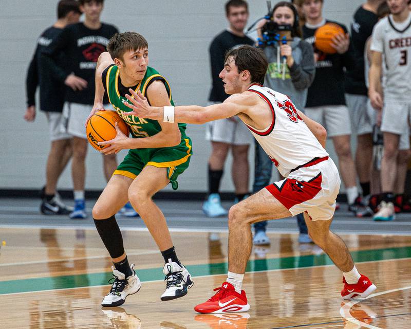 Brady Sheedy (25) of Seneca holds ball as Braden Curran (3) of Hall guards at hip during game in the Shipyard Showdown on Tuesday, December 23, 2025 at Seneca High School in Seneca.