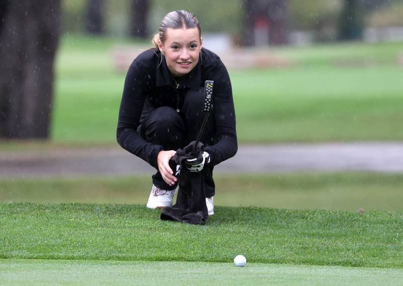 Sycamore DeKalb co-op’s Meadow Lee lines up her putt on the second hole Tuesday, Sept. 24, 2024, during the Interstate 8 girls golf tournament at the Sycamore Golf Club.